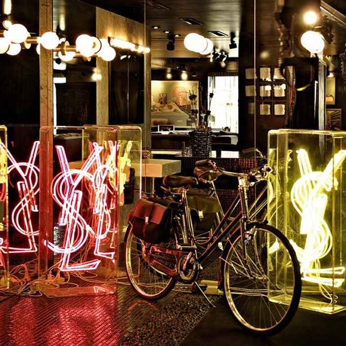 Bike and YSL neon lights at Cindy's Black Apartment.